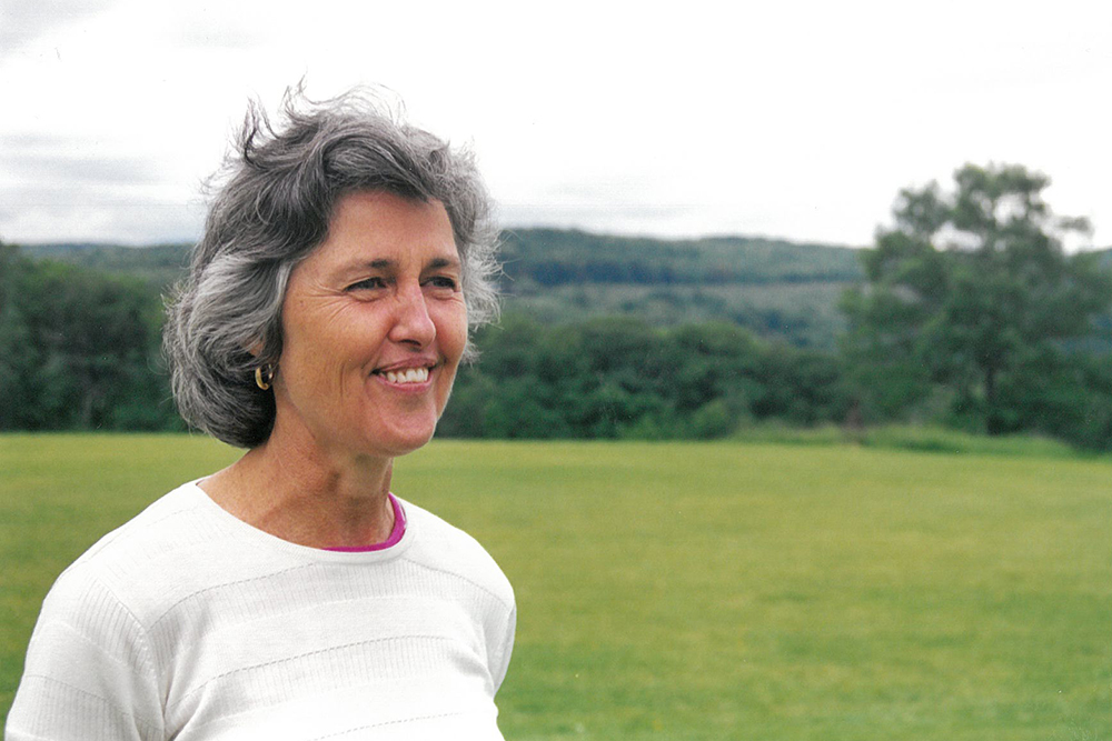 Sarah Gund standing in a field.