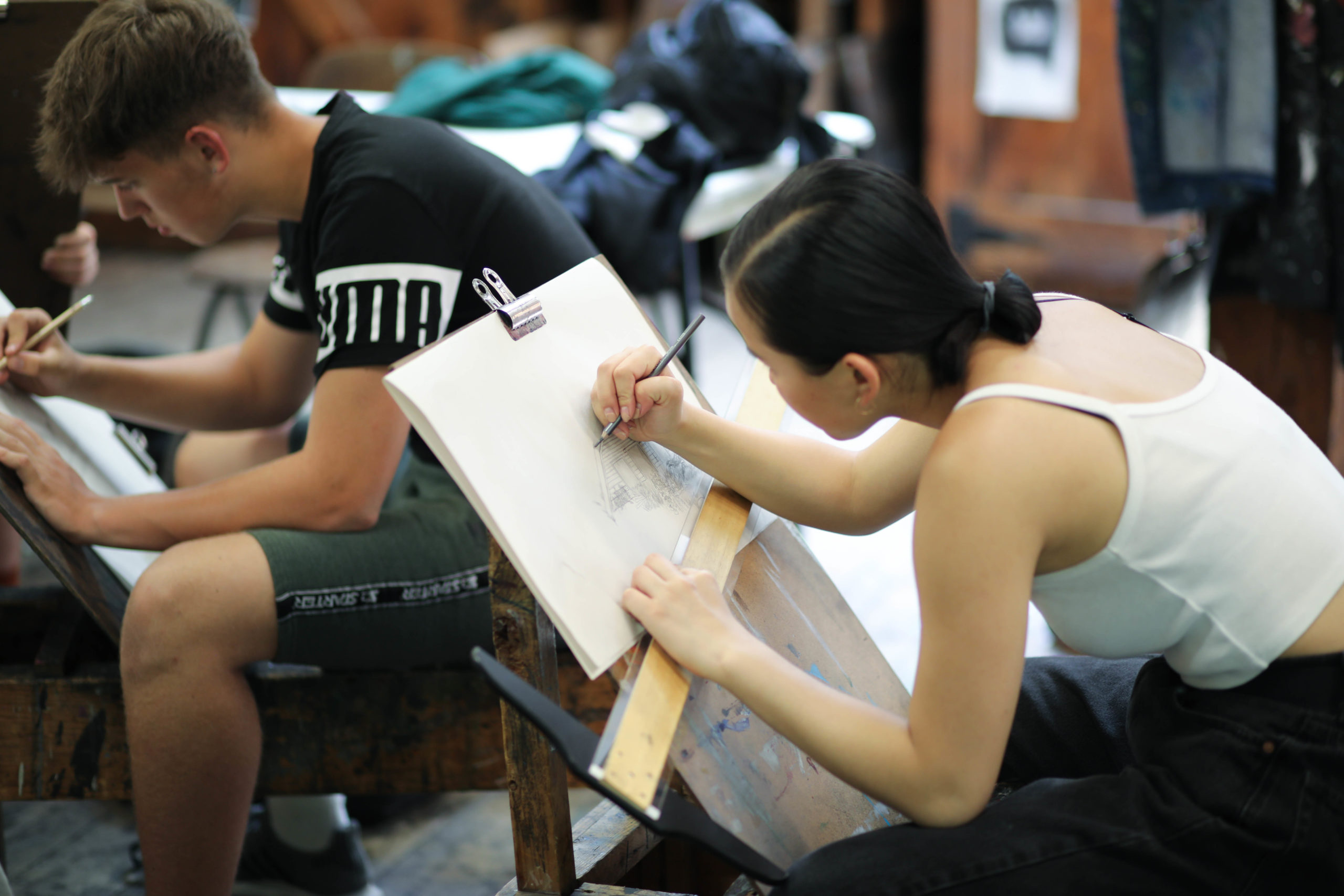 Student drawing on an easel